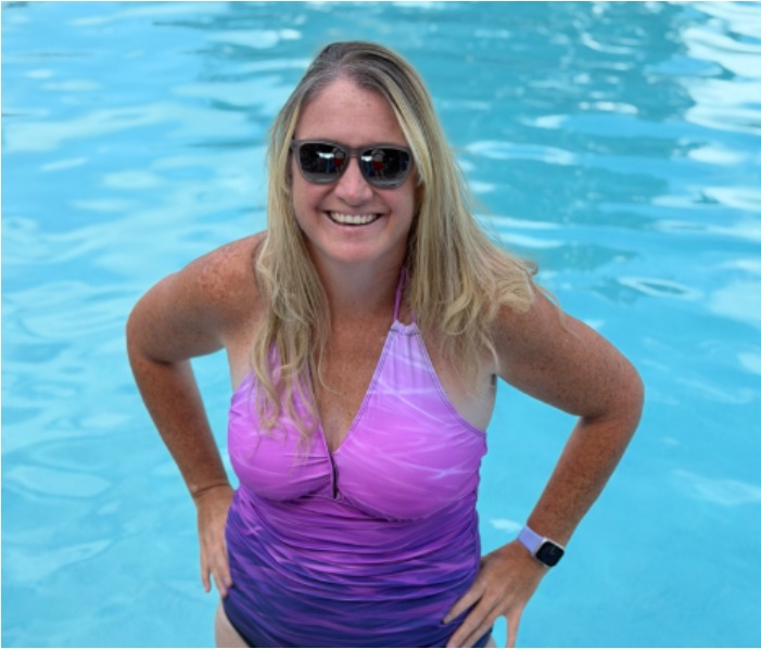 Coach Krystle Watson smiling in a swimming pool